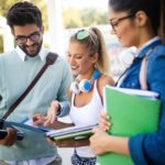 happy-young-university-students-friends-studying-with-books-at-university-2.jpg